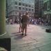 The street performer juggled 3 machetes while upside down
