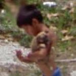 Small boy holding a puppy (StreetView)