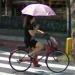 Holding an umbrella while cycling
