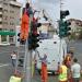 How many people does it take to install a traffic light?